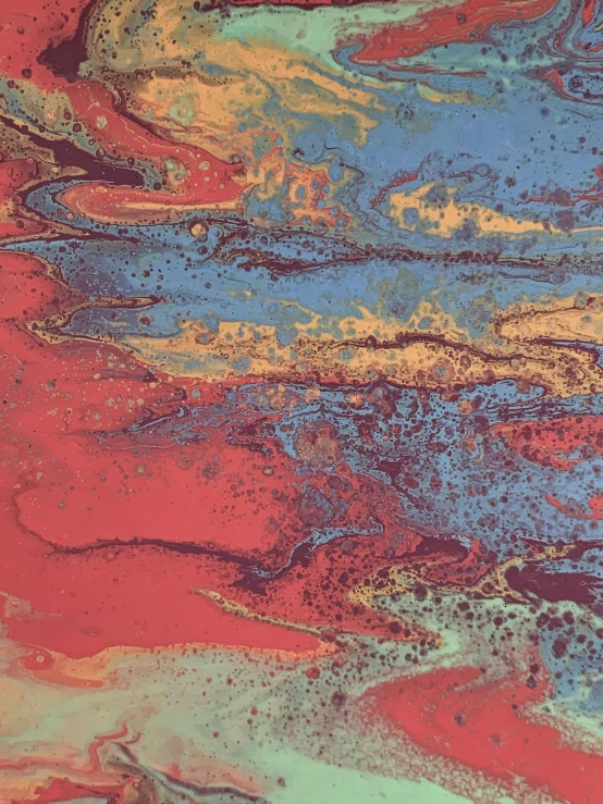 a close up of a painting on a table, inspired by Richter, trending on unsplash, melting in coral pattern, red blue and gold color scheme, richard pearce, marbled swirls