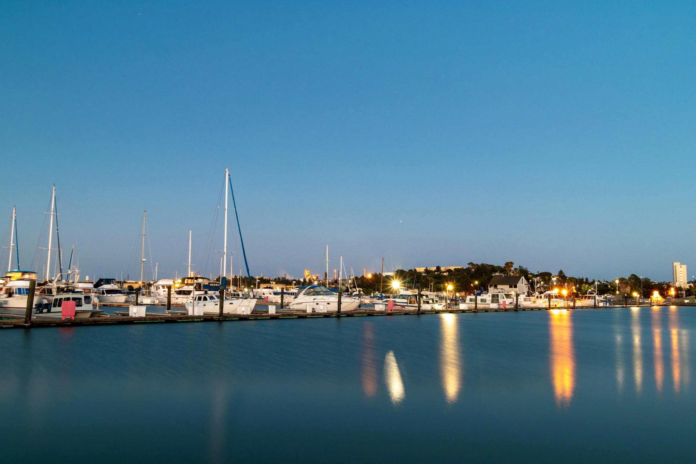 a harbor filled with lots of boats under a blue sky, by Tom Bonson, pexels contest winner, happening, night time footage, caulfield, panoramic, ignant