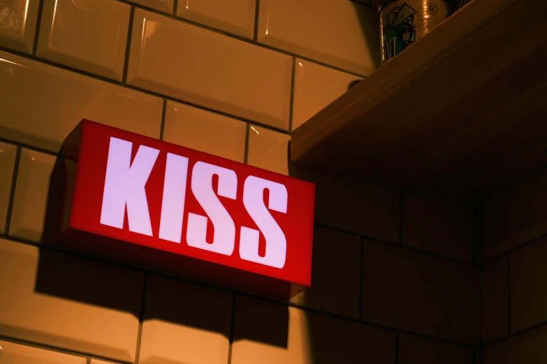 a red sign mounted to the side of a wall, an album cover, inspired by Elsa Bleda, unsplash, kiss mouth to mouth, diner scene, kris kuksi, king crimson