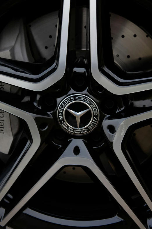 a close up of a wheel on a car, black and silver, mercedes, gun metal grey, white on black