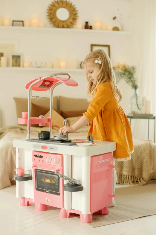a little girl playing with a pink toy kitchen, inspired by Jan Kupecký, lights on, easy to use, thumbnail, mini