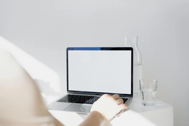 a woman using a laptop computer on a white table, a computer rendering, by Carey Morris, trending on unsplash, blank, filling with water, sitting in an empty white room, background image