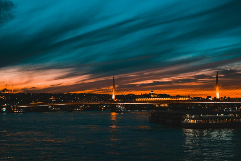 a bridge over a body of water at night, by Alexander Runciman, pexels contest winner, striped orange and teal, sunset panorama, fallout style istanbul, thumbnail