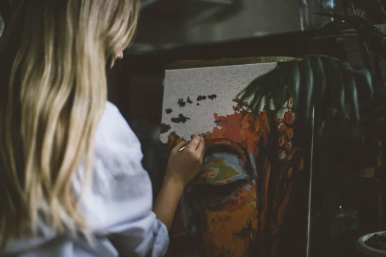 a woman standing in front of a painting, pexels contest winner, process art, paint on black velvet canvas, 🎨🖌, girl creates something great, facing away