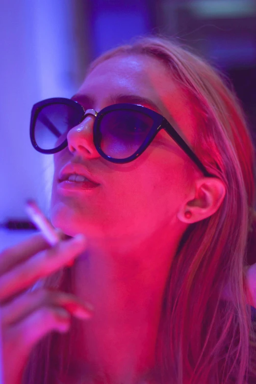 a woman in sunglasses smoking a cigarette, poster art, trending on pexels, happening, purple laser lighting, as she looks up at the ceiling, red and blue black light, advanced technology