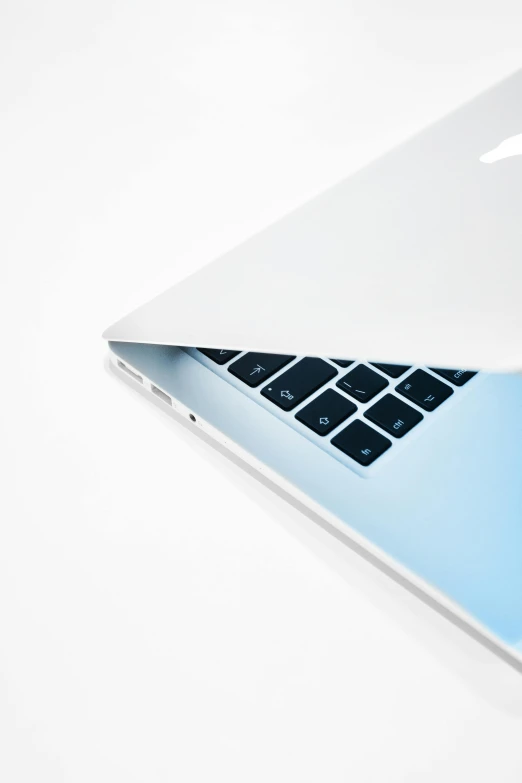 an open laptop computer sitting on top of a white table, by Carey Morris, unsplash, computer art, 2 5 6 x 2 5 6 pixels, white and pale blue, apple design, closeup photograph