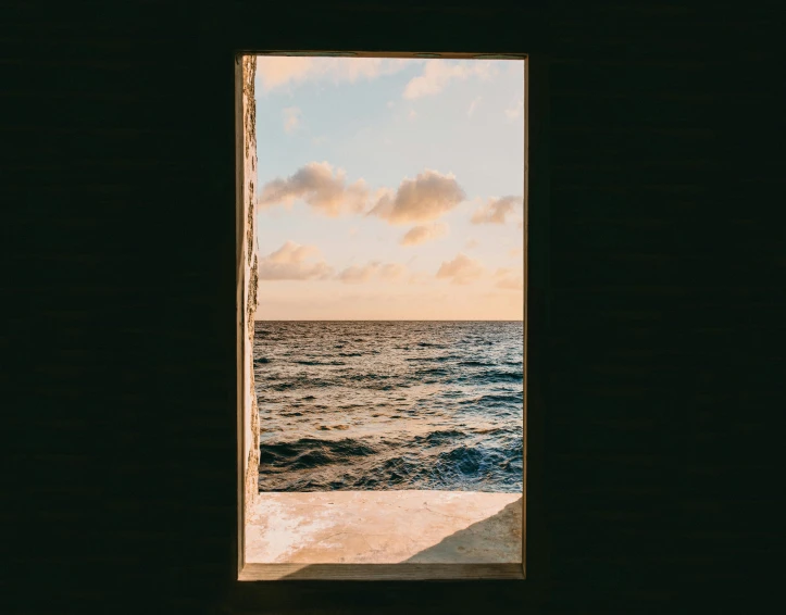 an open door with a view of the ocean, a picture, pexels contest winner, sunlit sky, brown, deep sea ambience, skybox