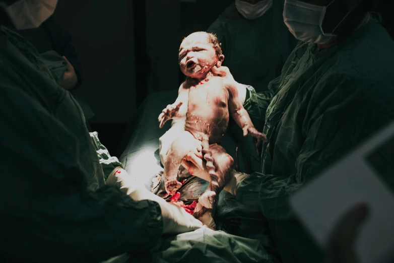 a close up of a person holding a baby, surgery, full body image, thumbnail, dramatic shot