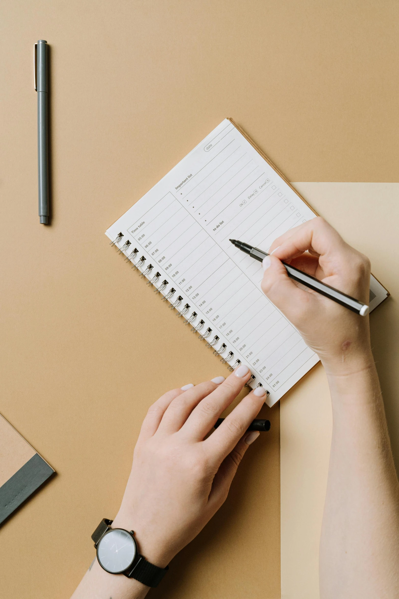 a person writing on a notebook next to a cup of coffee, by Daniel Seghers, trending on unsplash, centered design, plain background, detailed product image, flat lay