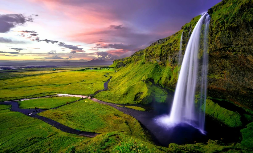 a waterfall in the middle of a lush green field, pexels contest winner, hurufiyya, at sunset, green and purple, conde nast traveler photo, high rendering