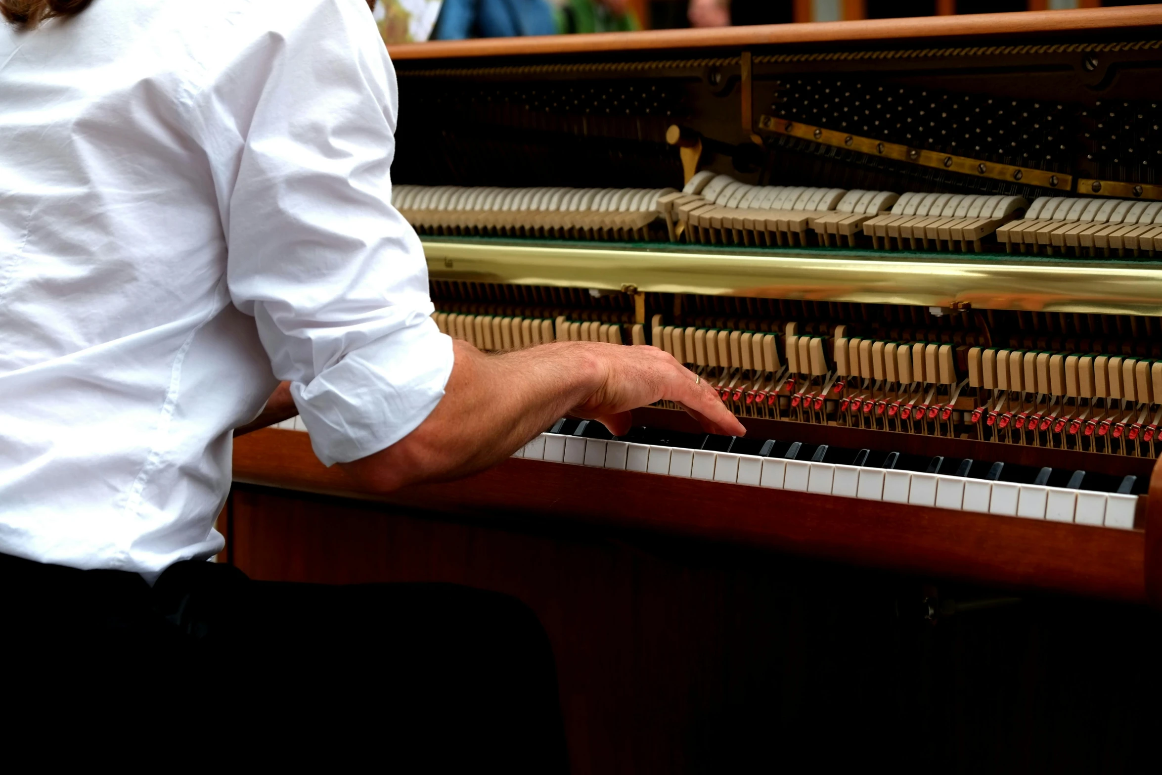 a close up of a person playing a piano, standing on top of a piano