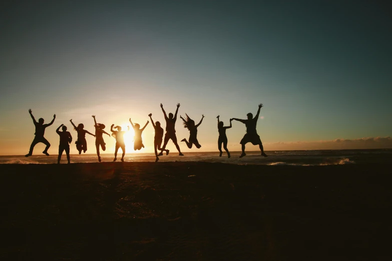 a group of people jumping in the air on a beach, taken at golden hour, profile image, groups of happy humans, instagram picture