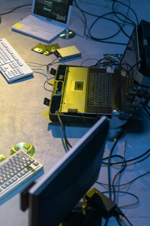 a group of computers sitting on top of a table, crusty electronics, yellow lighting from right, cyber embellishment, biohacking