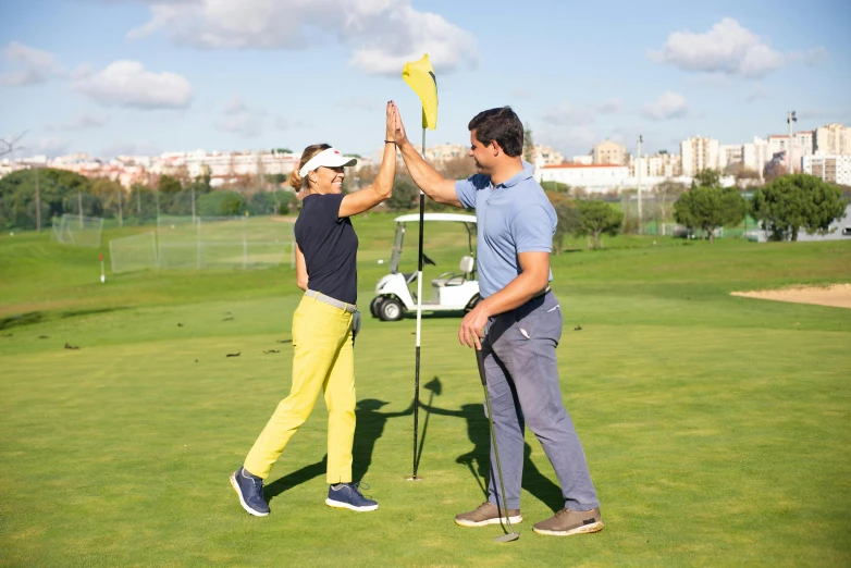 a man giving a woman a high five on a golf course, by Mathias Kollros, pexels contest winner, figuration libre, spanish, standing upright, avatar image