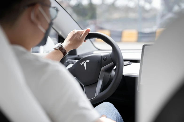 a person sitting in a car using a laptop, tesla, avatar image, unblur, high resolution image