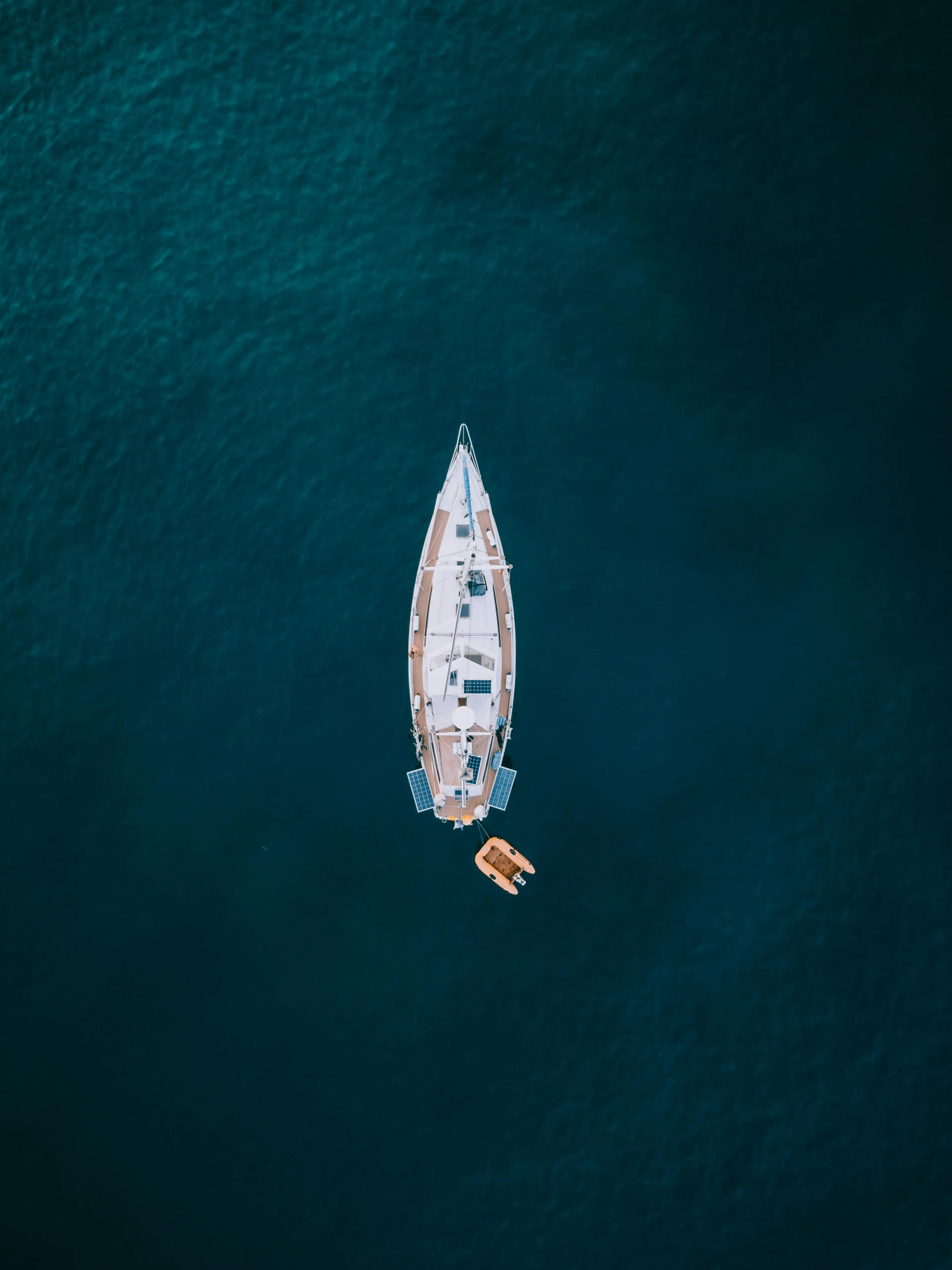 a boat floating in the middle of a body of water, by Sebastian Spreng, pexels contest winner, relaxing on a yacht at sea, top down camera angle, award winning cinematic, deep colour