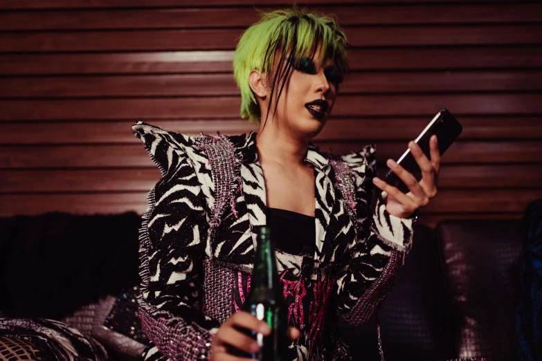 a woman with green hair using a cell phone, a photo, trending on pexels, glam rockers drinking wine, androgynous male, drag, dressed in punk clothing