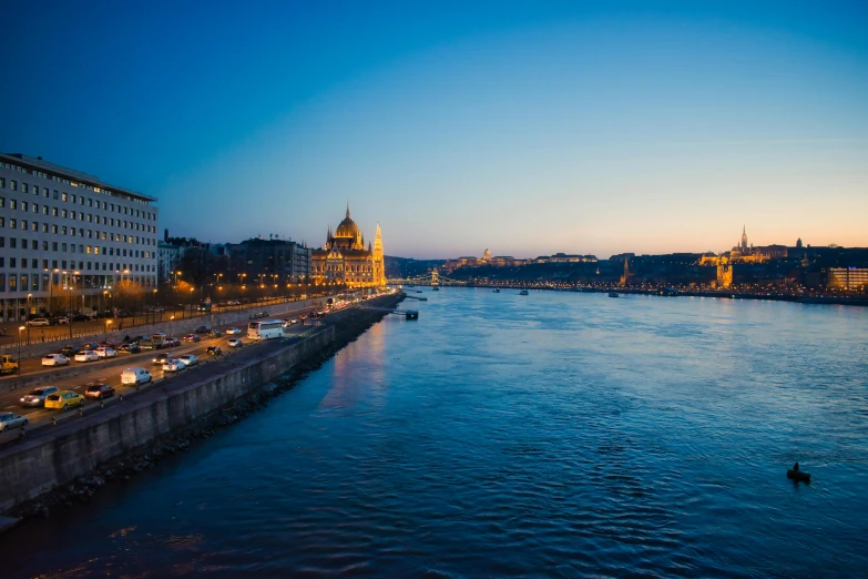 a river filled with lots of traffic next to tall buildings, by Josef Navrátil, pexels contest winner, art nouveau, budapest, calm evening, blue, thumbnail