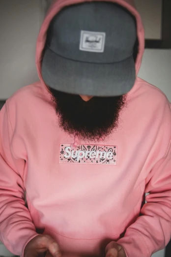 a man with a beard wearing a pink hoodie, inspired by Cam Sykes, supreme, smooth intricate, laced, detailed product shot