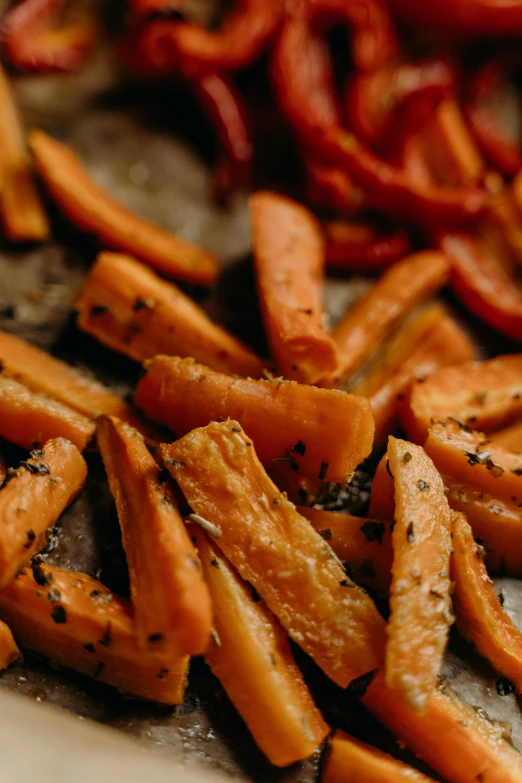 a pile of cut up carrots sitting on top of a cutting board, pexels, serving fries, woodfired, pepper, dynamic scene
