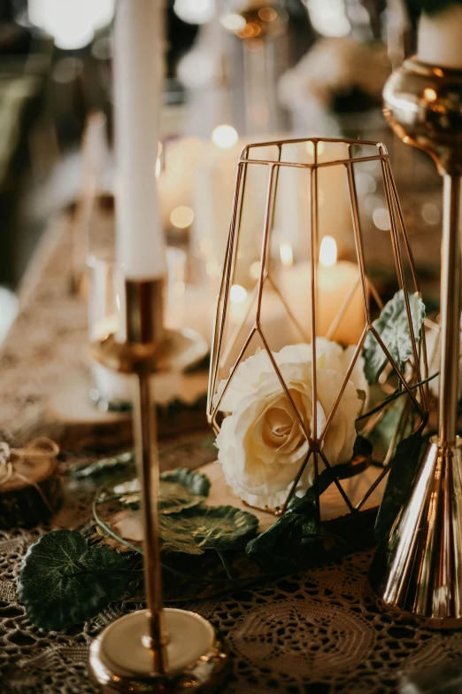 a close up of a table with candles and flowers, ultra detailed wire decoration, gold glow, upclose, candle lit