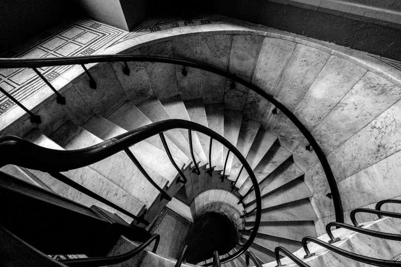 a black and white photo of a spiral staircase, by Sven Erixson, pexels, stone stairway, high - angle, louis kahn, mc escher!!