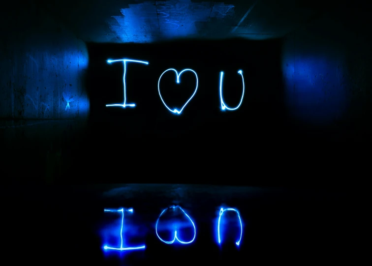 a couple of lights that are in the dark, inspired by Tracey Emin, unsplash, graffiti, i love you, blue reflections, ( ( ( ( volumetric light ) ) ) ), istockphoto