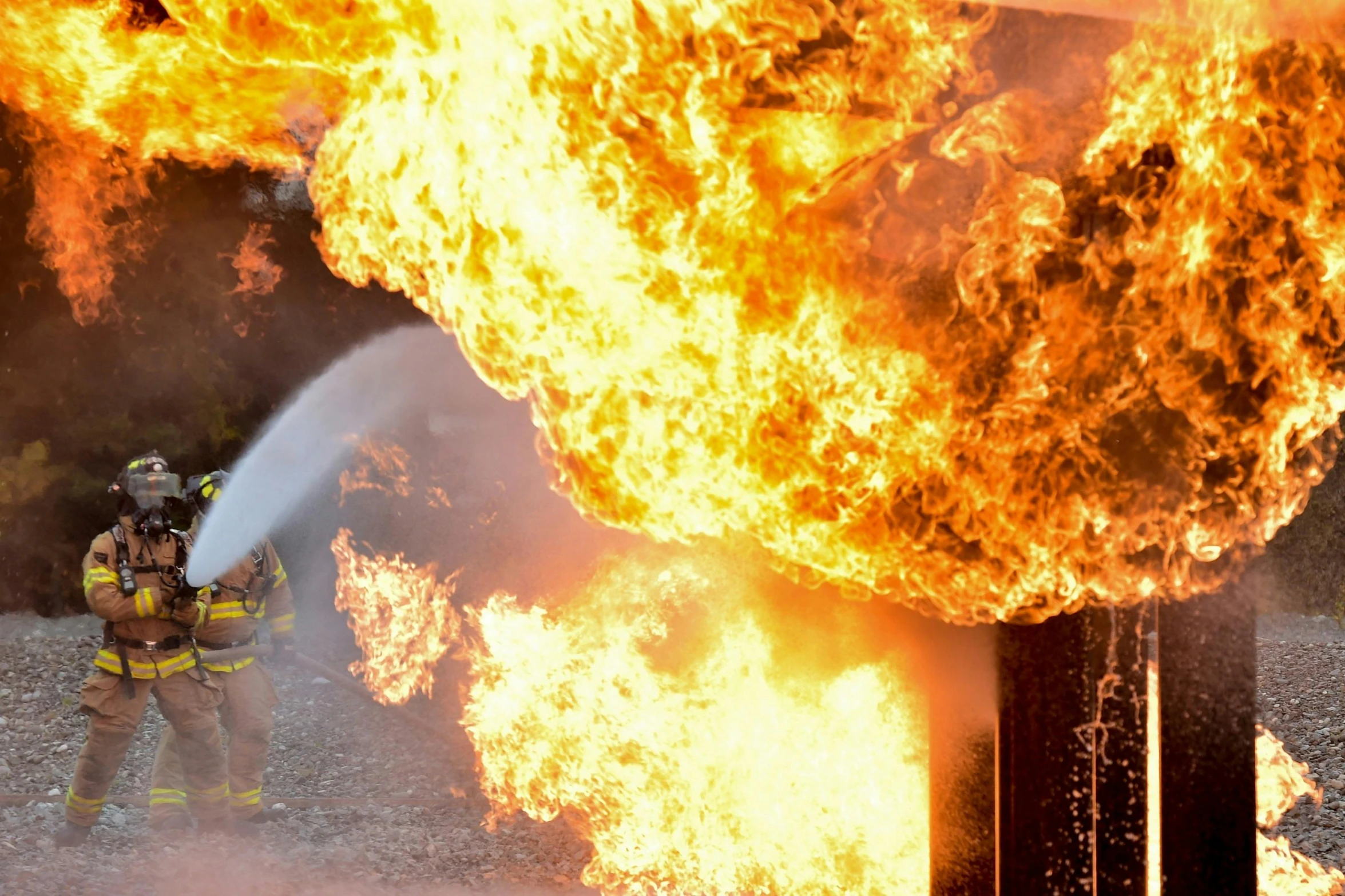 two firefighters are fighting a fire with a hose, pexels contest winner, train station explosion, gas fire in cracks, promo image, thumbnail