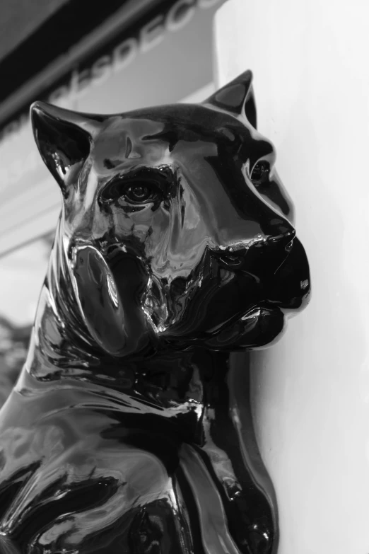 a black and white photo of a statue of a dog, by Jeff Koons, unsplash, photorealism, the smooth black jaguar, glazed ceramic, high gloss, 1957