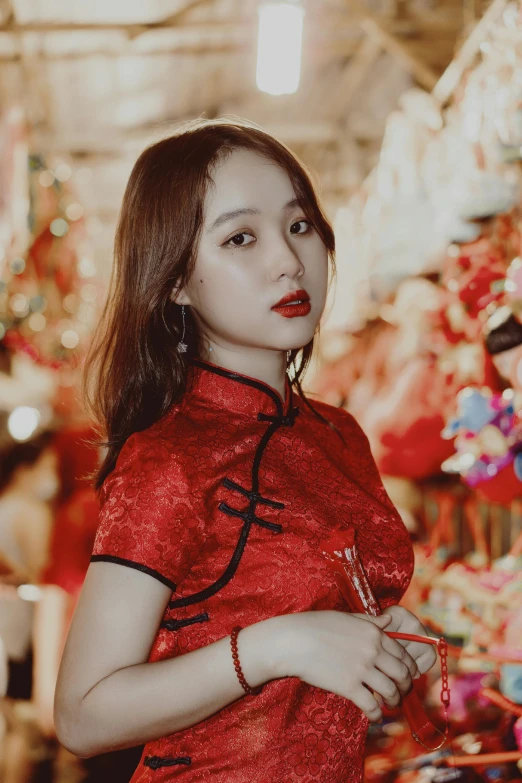 a woman in a red dress posing for a picture, an album cover, inspired by Huang Ji, tumblr, lovingly looking at camera, wearing festive clothing, market, ruan jia beautiful!