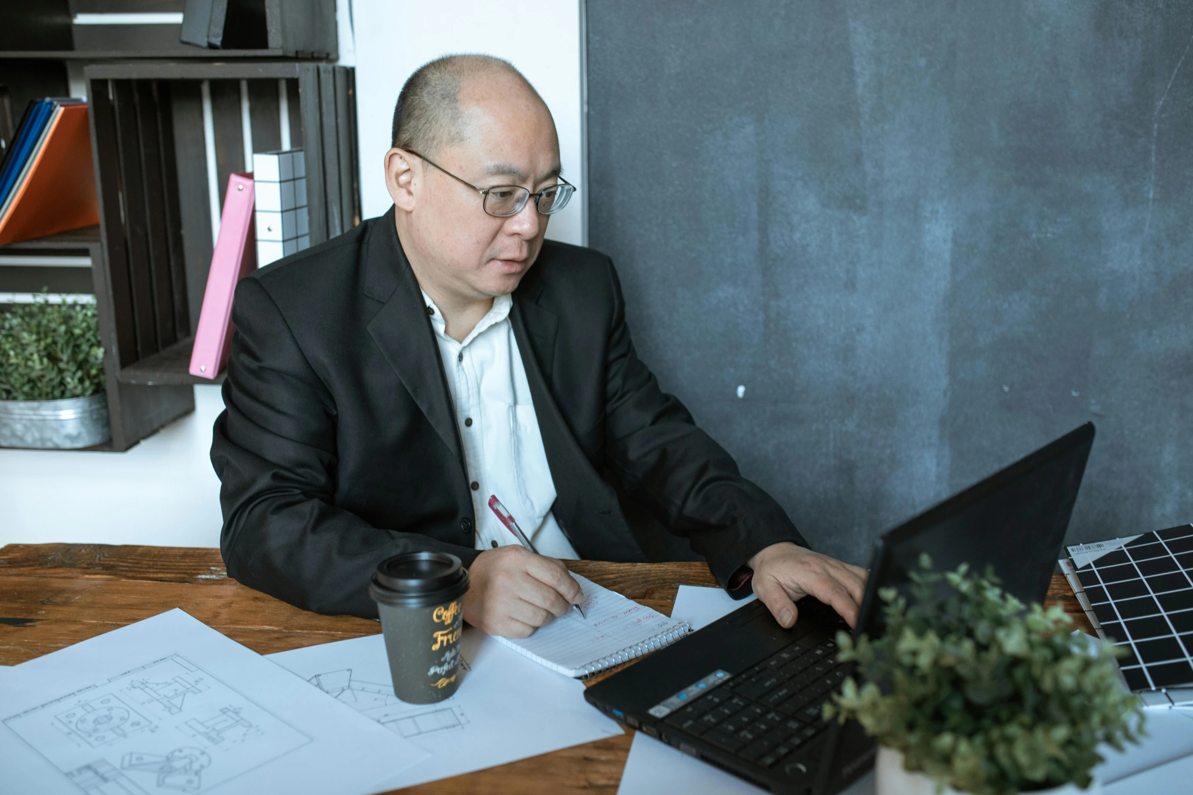 a man sitting at a table working on a laptop, a cartoon, by Jang Seung-eop, pexels contest winner, gutai group, academy headmaster, 15081959 21121991 01012000 4k, instagram post, professional profile picture