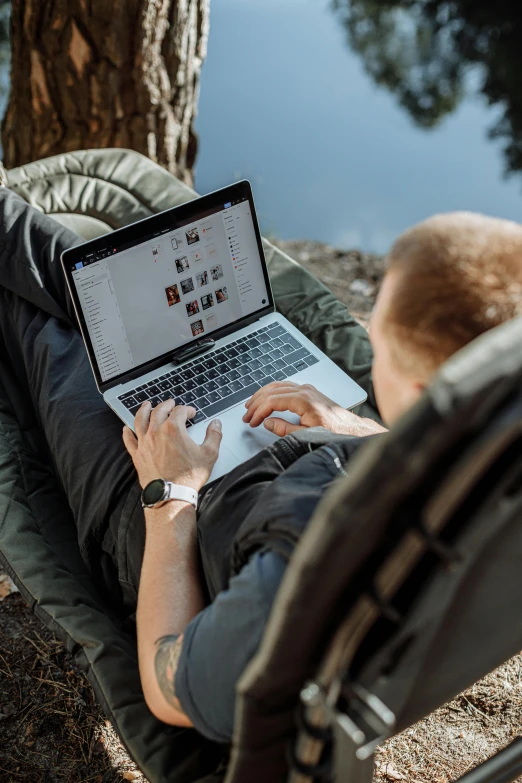 a man sitting in a hammock using a laptop computer, pexels contest winner, happening, hunting, avatar image, instagram picture, multi-part