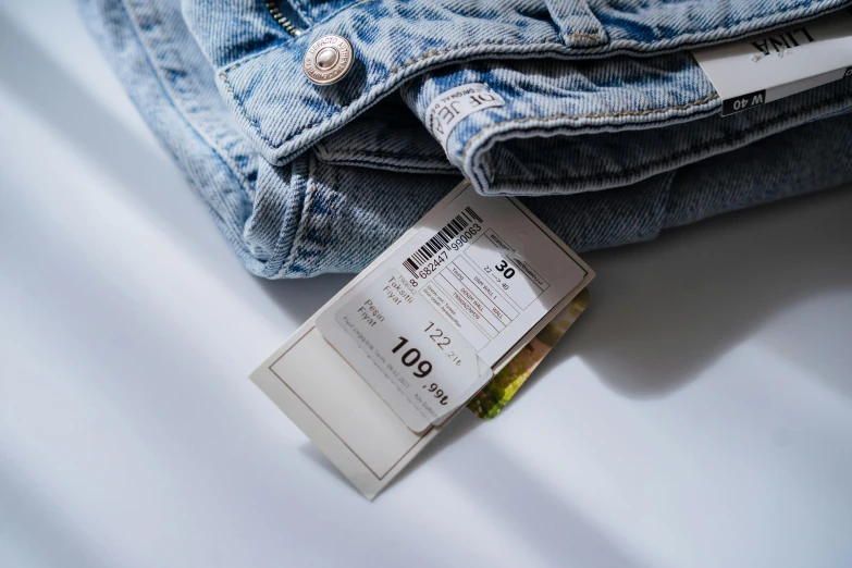 a close up of a pair of jeans with a price tag, a picture, by Daniel Lieske, trending on pexels, wearing a vest top, barcodes, jovana rikalo, shot on sony a 7 iii