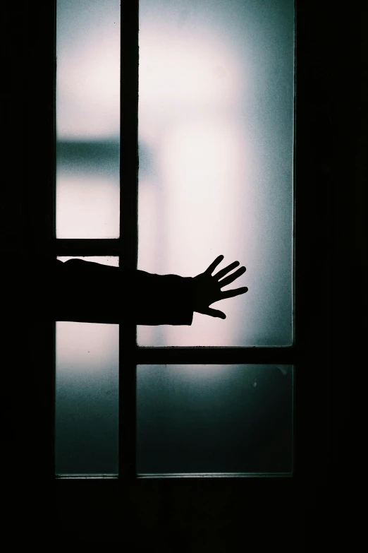 a silhouette of a person standing in front of a window, an album cover, unsplash, black hands with black claws, restrained, leaving a room, freezing