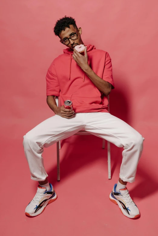 a man sitting on a chair talking on a cell phone, inspired by Louis Hersent, trending on pexels, pink and red color style, yzy gap, drake, white pants