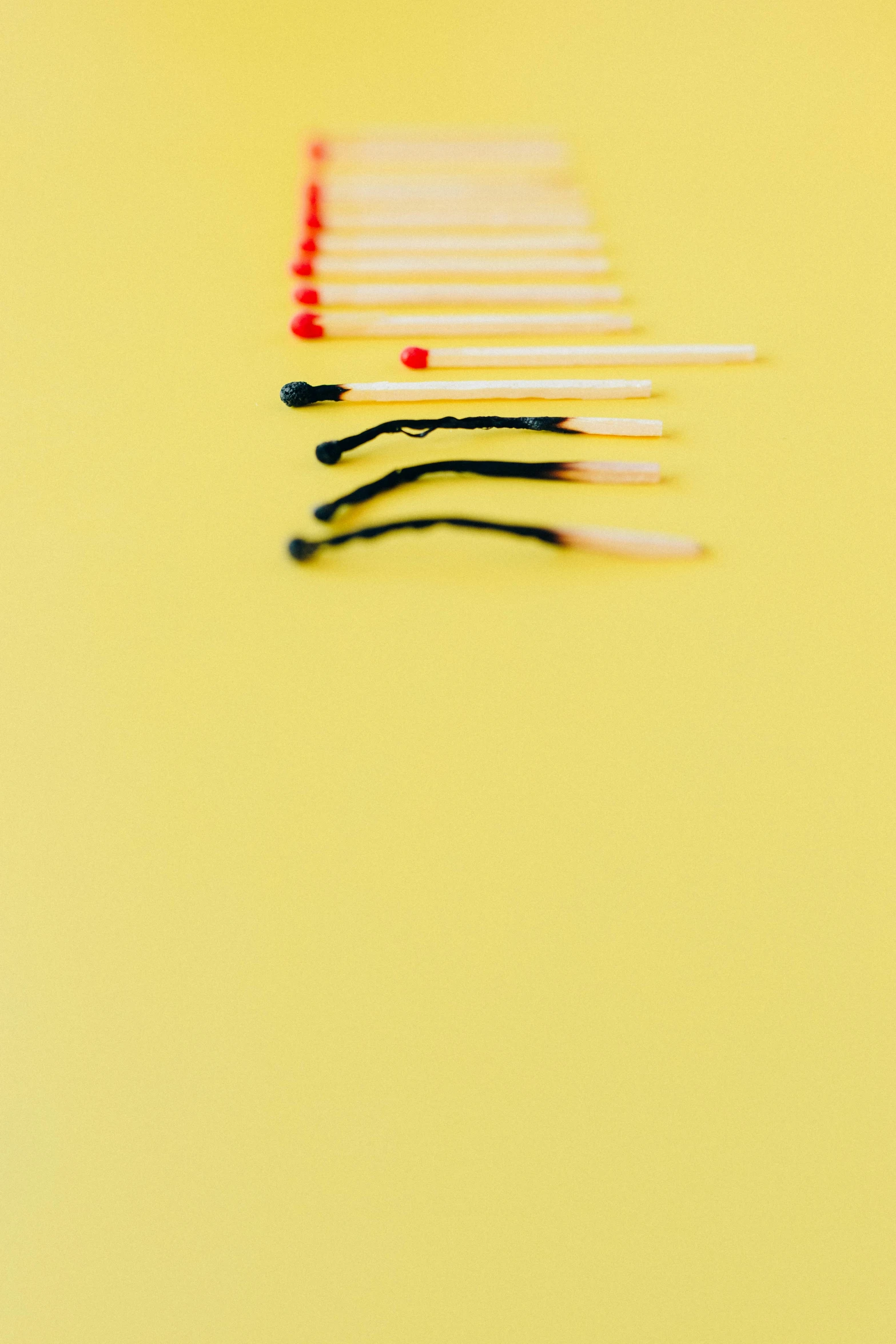 a row of matches on a yellow surface, a picture, by Carey Morris, pexels, high contrast portra 400, shot on hasselblad, emotions, 256435456k film