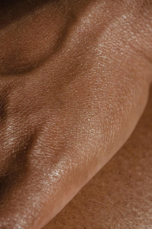 a close up of a person's hand with a ring on it, an album cover, by artist, hyperrealism, brown skin like soil, wrinkled muscles skin, noticeable tear on the cheek, deep tan skin