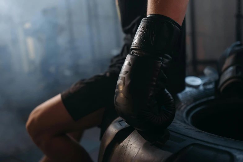a close up of a person wearing boxing gloves, black draconic - leather, manuka, vintage glow, product shot