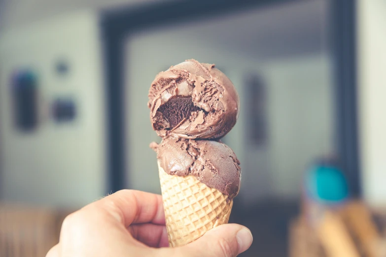 a close up of a person holding an ice cream cone, pexels contest winner, fully chocolate, grey, deep colour, handcrafted