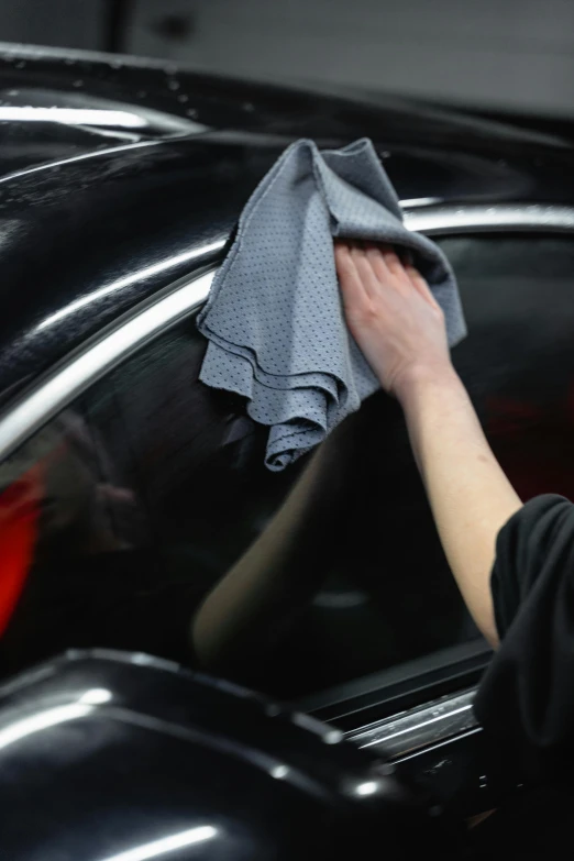 a woman wiping a car with a cloth, gunmetal grey, thumbnail, performance, fineline detail