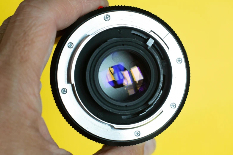 a close up of a person holding a camera lens, 8 0 s camera, sigma art lens, highly microdetailed, f/3.2