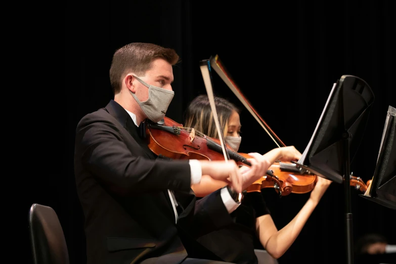 a man in a suit playing a violin, masked female violinists, high school, profile image