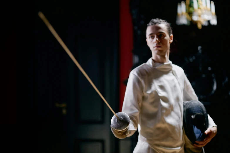 a man in a fencing stance holding a sword, a portrait, by Helen Stevenson, unsplash, fine dining, ( ( theatrical ) ), edmund blair and charlie bowater, wearing silver silk robe