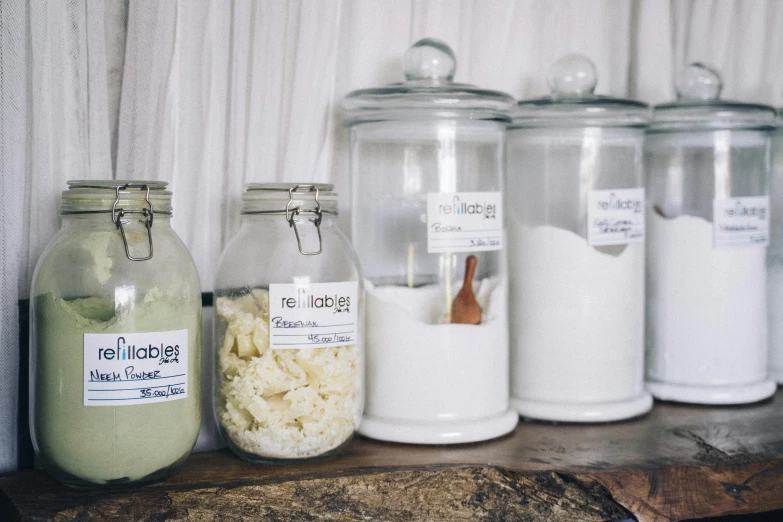 a bunch of jars sitting on top of a wooden shelf, detailed product image, light cream and white colors, degradation, rebel