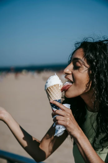 a woman eating an ice cream cone on the beach, pexels contest winner, renaissance, an olive skinned, 1 2 9 7, wavy, licking out