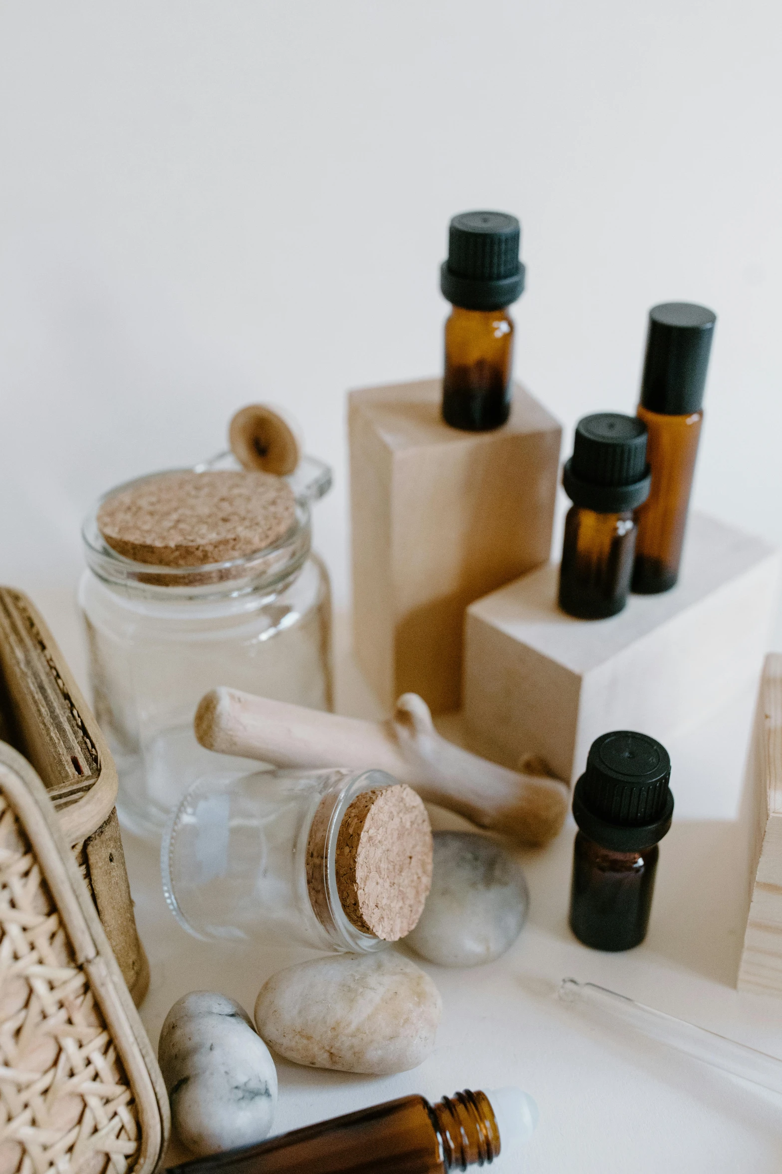 a bunch of bottles sitting on top of a table, a still life, by Nicolette Macnamara, trending on pexels, bark for skin, miniature product photo, incense, set against a white background