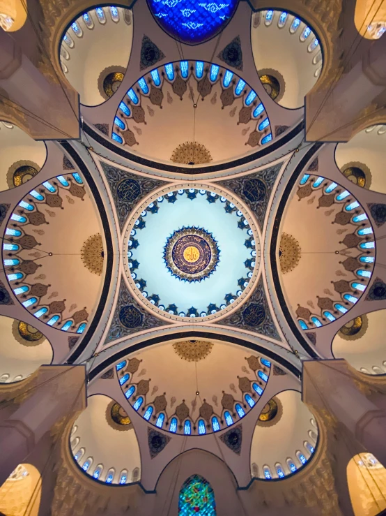 the ceiling of a church with stained glass windows, inspired by Osman Hamdi Bey, trending on unsplash, inside a dome, kuala lumpur, looking up at camera, taken in the late 2000s