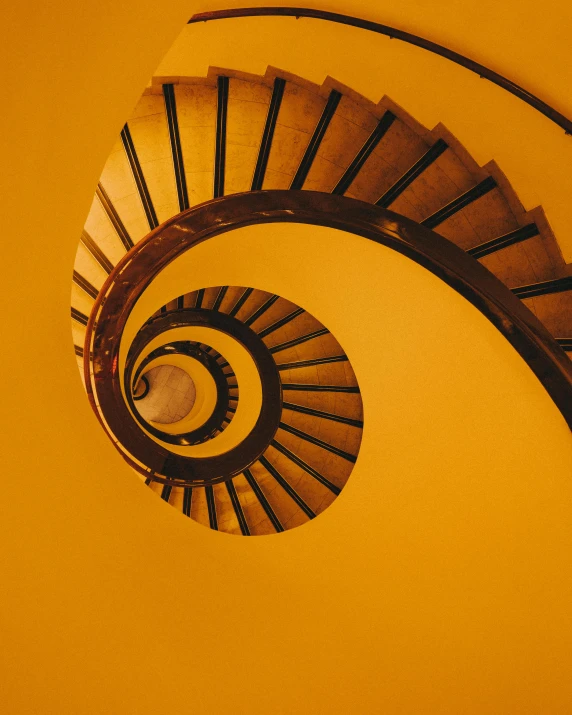 a spiral staircase in a yellow room, pexels contest winner, vibrant but dreary gold, frank gehry, ochre, album cover