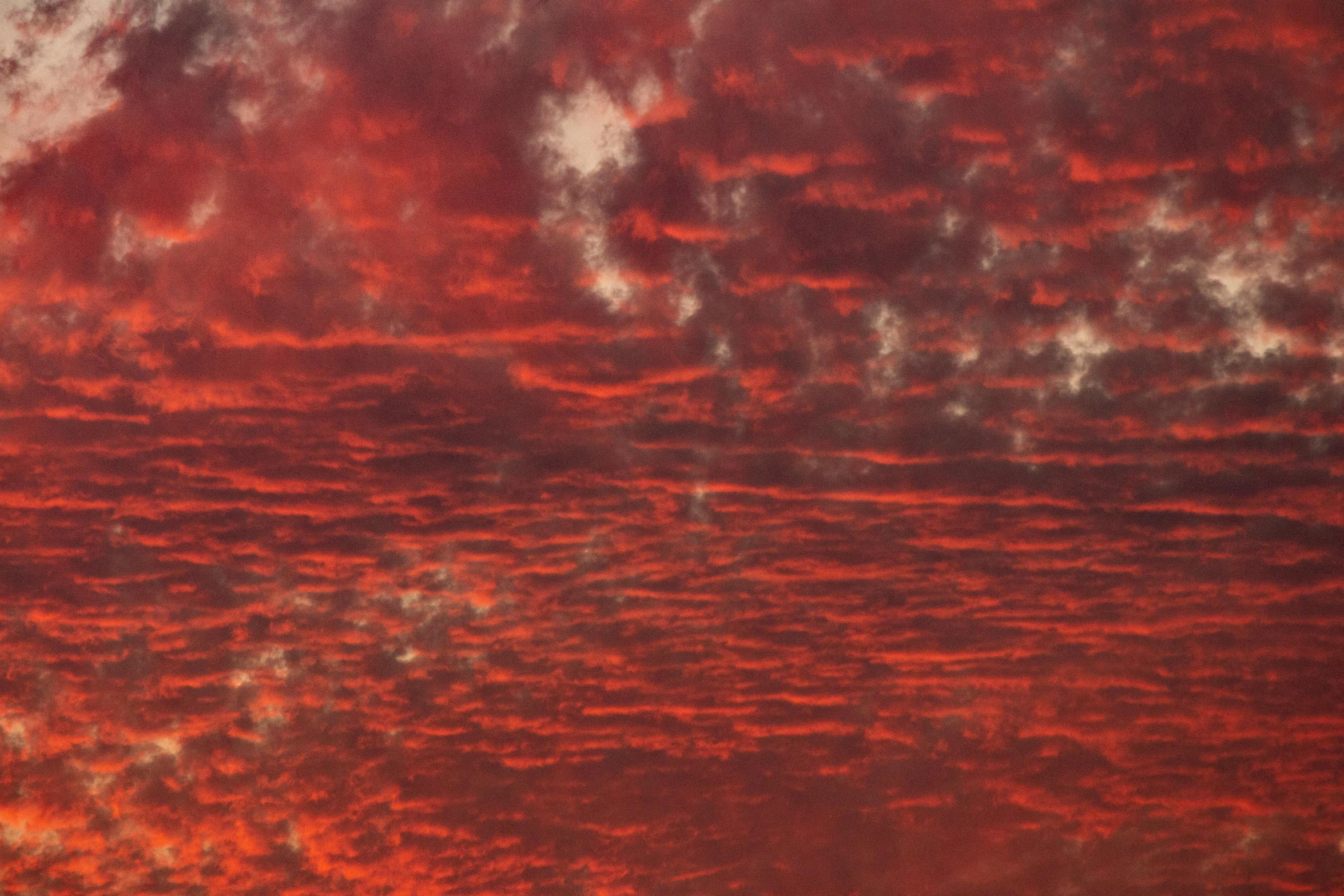 a large jetliner flying through a red sky, an album cover, inspired by Frederic Church, flickr, romanticism, layered stratocumulus clouds, refracted sunset, ignant, red liquid