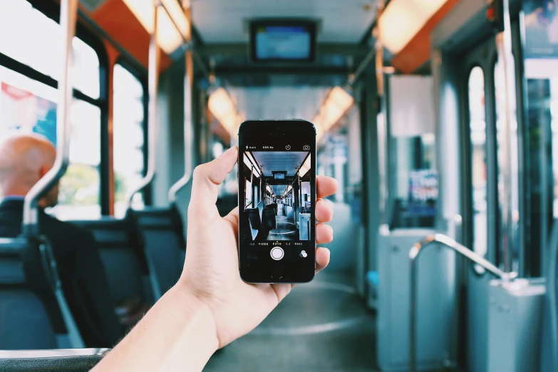 a person taking a picture of the inside of a bus, a picture, by Niko Henrichon, unsplash contest winner, a painting of an iphone, train far, 2 5 6 x 2 5 6 pixels, holding it out to the camera